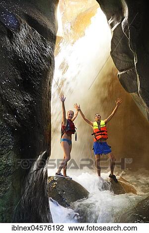 Young couple under waterfall at the canyon of Wadi Mujib, Jordan, Asia View Large Photo Image Stock Image - Young couple under waterfall at the canyon of Wadi Mujib, Jordan, Asia. Fotosearch