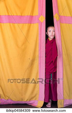 Young monk looking out from behind a curtain, Amitabha Monastery, Kathmandu Valley, Kathmandu, Nepal, Asia View Large Photo Image Stock Photo - Young monk looking out from behind a curtain, Amitabha Monastery, Kathmandu Valley, Kathmandu, Nepal, Asia. Fotosearch