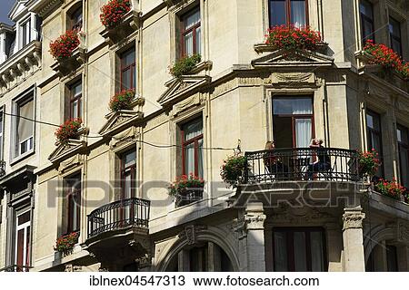 Stock Image - Young woman having breakfast on the balcony, Tabora, city center, Brussels, Belgium, Europe. Fotosearch