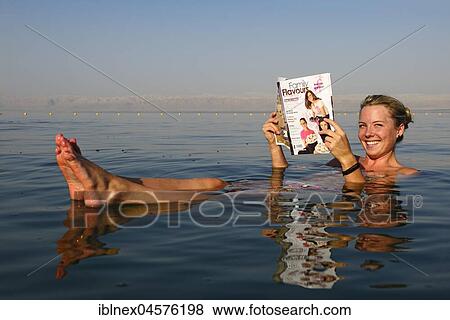 Young woman reads newspaper floating in Dead Sea, Jordan, Asia View Large Photo Image Stock Photo - Young woman reads newspaper floating in Dead Sea, Jordan, Asia. Fotosearch