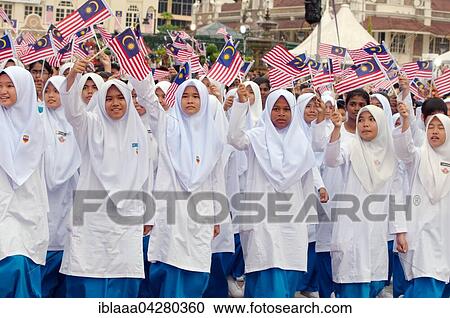 Stock Image - Young women with Malaysian flags on September 16, Independence Day Hari Merdeka, Kuala Lumpur, Malaysia, Asia. Fotosearch