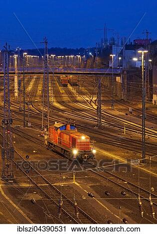 A lone locomotive running in the freight train depot, Hagen, Ruhr District, North Rhine-Westphalia, Germany, Europe View Large Photo Image Stock Image - A lone locomotive running in the freight train depot, Hagen, Ruhr District, North Rhine-Westphalia, Germany, Europe. Fotosearch