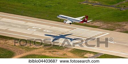 Stock Photo - Aerial view, Düsseldorf Airport, landing jet, Embraer, MSN 387, HB-JVP Helvetic Airways, Düsseldorf, Rhineland, North Rhine-Westphalia, Germany, Europe. Fotosearch