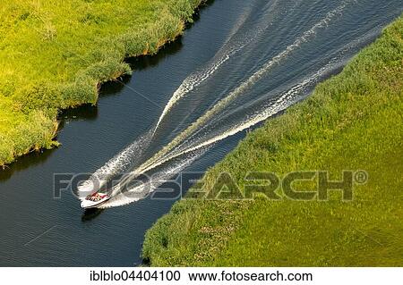 Stock Image - Aerial view, motor boat on Peene River, Mecklenburg Lake Plateau, Mecklenburg-Western Pomerania, Germany, Europe. Fotosearch