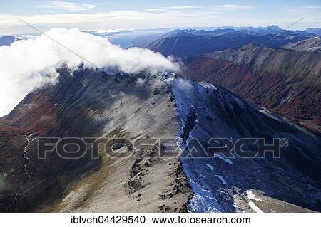 Aerial view of Tierra del Fuego National Park, clouds with Lake Fagnano, Tierra del Fuego, Andes, Argentina, South America View Large Photo Image Stock Image - Aerial view of Tierra del Fuego National Park, clouds with Lake Fagnano, Tierra del Fuego, Andes, Argentina, South America. Fotosearch