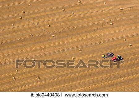 Aerial view, tractors baling straw in field, Neukalen, Mecklenburg Lake Plateau, Mecklenburg-Western Pomerania, Germany, Europe View Large Photo Image Stock Image - Aerial view, tractors baling straw in field, Neukalen, Mecklenburg Lake Plateau, Mecklenburg-Western Pomerania, Germany, Europe. Fotosearch