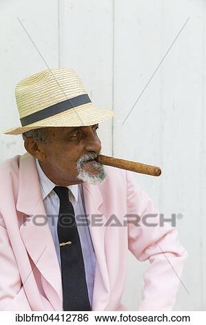Aged Cuban man with straw hat smokes cigar, Trinidad, Sancti Spíritus Province, Cuba, Central America View Large Photo Image Stock Photograph - Aged Cuban man with straw hat smokes cigar, Trinidad, Sancti Spíritus Province, Cuba, Central America. Fotosearch