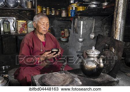 Ani Chorten, daughter of Tashi Lama, is praying before drinking tibetan butter tea, Praken Gompa, Manang, Manang District, Nepal, Asia View Large Photo Image Stock Image - Ani Chorten, daughter of Tashi Lama, is praying before drinking tibetan butter tea, Praken Gompa, Manang, Manang District, Nepal, Asia. Fotosearch