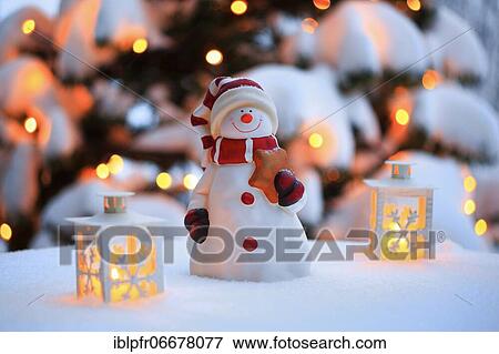 Atmospheric outdoor Christmas decoration with snowman, lanterns, snow and fairy lights on Christmas tree View Large Photo Image Stock Photo - Atmospheric outdoor Christmas decoration with snowman, lanterns, snow and fairy lights on Christmas tree. Fotosearch