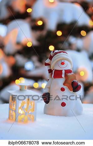 Atmospheric outdoor Christmas decoration with snowman, lanterns, snow and fairy lights on Christmas tree View Large Photo Image Stock Photo - Atmospheric outdoor Christmas decoration with snowman, lanterns, snow and fairy lights on Christmas tree. Fotosearch