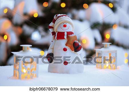 Atmospheric outdoor Christmas decoration with snowman, lanterns, snow and fairy lights on Christmas tree View Large Photo Image Stock Photo - Atmospheric outdoor Christmas decoration with snowman, lanterns, snow and fairy lights on Christmas tree. Fotosearch