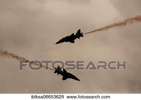 Stock Photo - BAE Systems Hawk two aircraft of the Royal Air Force Red Arrows display team in flight, Cambridgeshire, England, United Kingdom, Europe. Fotosearch