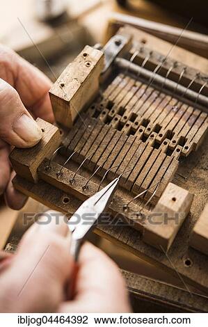 Barrel organ builder, hand bends spring wires made of V2A steel into wooden valves, Grassau, Upper Bavaria, Bavaria, Germany, Europe View Large Photo Image Stock Image - Barrel organ builder, hand bends spring wires made of V2A steel into wooden valves, Grassau, Upper Bavaria, Bavaria, Germany, Europe. Fotosearch