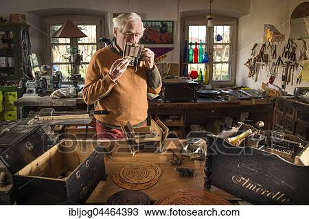 Barrel organ builder, workshop, man blowing into sound post, checking tones with his mouth, Grassau, Upper Bavaria, Bavaria, Germany, Europe View Large Photo Image Stock Image - Barrel organ builder, workshop, man blowing into sound post, checking tones with his mouth, Grassau, Upper Bavaria, Bavaria, Germany, Europe. Fotosearch