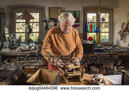 Barrel organ builder, workshop, man puts sound post between bellows, Grassau, Upper Bavaria, Bavaria, Germany, Europe View Large Photo Image Stock Photograph - Barrel organ builder, workshop, man puts sound post between bellows, Grassau, Upper Bavaria, Bavaria, Germany, Europe. Fotosearch