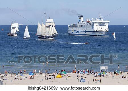Boat transport, ferry and sailing boats, Hanse-Sail, Warnemünde Beach, Mecklenburg-Western Pomerania, Germany, Europe View Large Photo Image Stock Photo - Boat transport, ferry and sailing boats, Hanse-Sail, Warnemünde Beach, Mecklenburg-Western Pomerania, Germany, Europe. Fotosearch