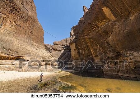 Picture - Boy at Guelta d'Archei waterhole, Rock gorge, Ennedi plateau, Chad, Africa. Fotosearch