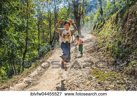 Boy jumping happily on dirt road, Palaung hilltribe, Palaung Village in Kyaukme, Shan State, Myanmar, Asia View Large Photo Image Stock Photo - Boy jumping happily on dirt road, Palaung hilltribe, Palaung Village in Kyaukme, Shan State, Myanmar, Asia. Fotosearch