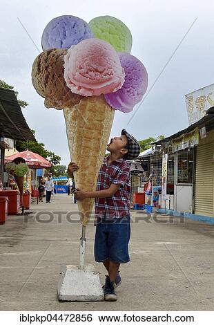 Boy with oversized cardboard ice cream cone, Phnom Penh Province, Cambodia, Asia View Large Photo Image Stock Photograph - Boy with oversized cardboard ice cream cone, Phnom Penh Province, Cambodia, Asia. Fotosearch