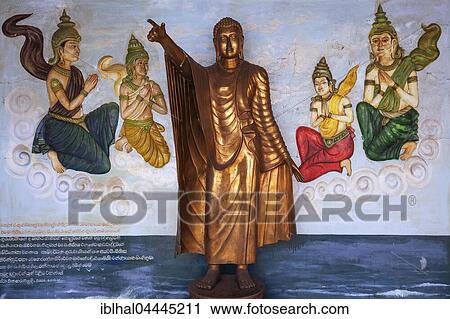 Stock Image - Bronze Buddha statue, Standing Buddha, mural, Weherahena Temple, Matara, Southern Province, Sri Lanka, Asia. Fotosearch