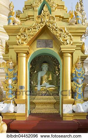 Stock Photograph - Buddha statue in a stupa, Shwedagon pagoda, Shwedagon Paya, Yangon, Myanmar, Asia. Fotosearch
