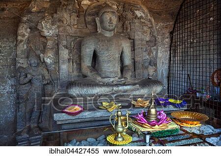Buddha statue with offerings, Gal Vihara, Sacred City, Polonnaruwa, North Central Province, Sri Lanka, Asia View Large Photo Image Stock Photography - Buddha statue with offerings, Gal Vihara, Sacred City, Polonnaruwa, North Central Province, Sri Lanka, Asia. Fotosearch
