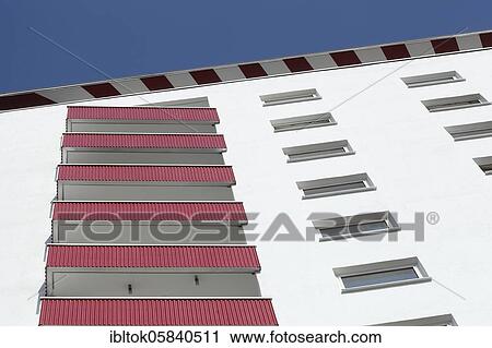 Stock Image - Building facade with red balconies and windows on a residential building, Bremerhaven, Bremen, Germany, Europe. Fotosearch