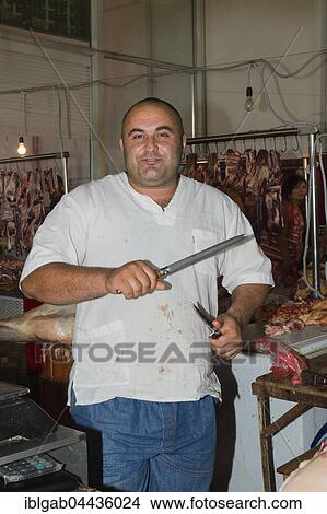 Picture - Butcher sharpening knife for cutting meat, Samal Bazar, Shymkent, South Region, Kazakhstan, For editorial use only, Asia. Fotosearch