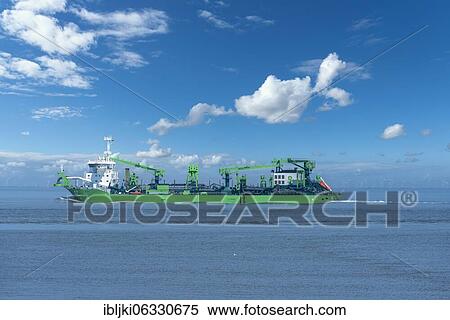 Stock Photography - Cargo ship with cranes on the world shipping route Elbe, Cuxhaven, Lower Saxony, Germany, Europe. Fotosearch