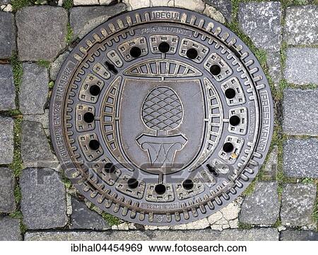 Cast iron ore manhole cover engraved with stone pine and Augsburg coat of arms, Augsburg, Bavaria, Germany, Europe View Large Photo Image Stock Photo - Cast iron ore manhole cover engraved with stone pine and Augsburg coat of arms, Augsburg, Bavaria, Germany, Europe. Fotosearch