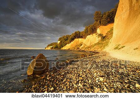 Chalk cliffs in early morning light, dark storm clouds, boulder, Jasmund National Park, Rügen, Mecklenburg-Western Pomerania, Germany, Europe View Large Photo Image Stock Image - Chalk cliffs in early morning light, dark storm clouds, boulder, Jasmund National Park, Rügen, Mecklenburg-Western Pomerania, Germany, Europe. Fotosearch
