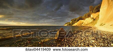 Chalk cliffs in early morning light, dark clouds, boulder, Jasmund National Park, Rügen, Mecklenburg-Western Pomerania, Germany, Europe View Large Photo Image Stock Photo - Chalk cliffs in early morning light, dark clouds, boulder, Jasmund National Park, Rügen, Mecklenburg-Western Pomerania, Germany, Europe. Fotosearch