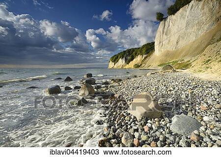 Stock Image - Chalk cliffs in morning light, boulders on beach, Jasmund National Park, Rügen, Mecklenburg-Western Pomerania, Germany, Europe. Fotosearch