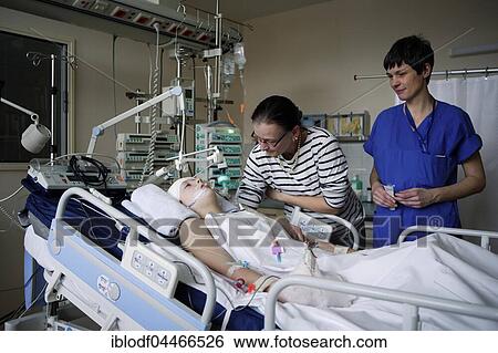 Child with mother and intensive care nurse at the bedside, ICU, Altona Children's Hospital, Hamburg, Germany, Europe View Large Photo Image Stock Photograph - Child with mother and intensive care nurse at the bedside, ICU, Altona Children's Hospital, Hamburg, Germany, Europe. Fotosearch
