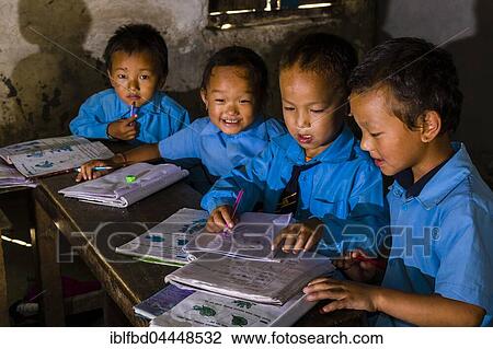 Children in blue dresses, sitting at a table in the local school, studying, Tatopani, Myagdi District, Nepal, Asia View Large Photo Image Stock Image - Children in blue dresses, sitting at a table in the local school, studying, Tatopani, Myagdi District, Nepal, Asia. Fotosearch