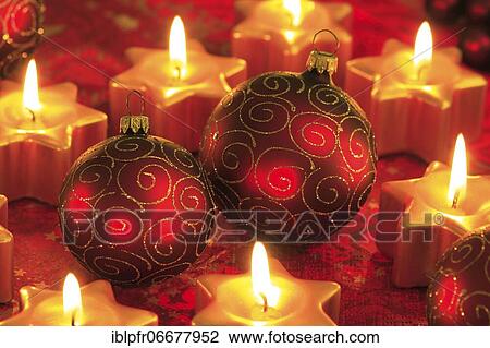 Stock Image - Christmas decoration with Christmas tree balls and star shaped candles. Fotosearch