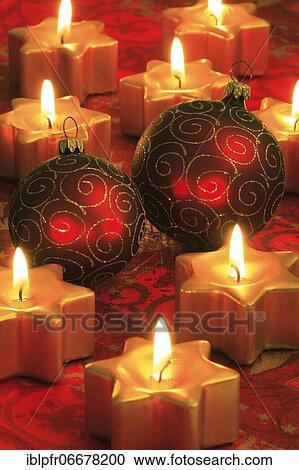 Stock Image - Christmas decoration with Christmas tree balls and star shaped candles. Fotosearch