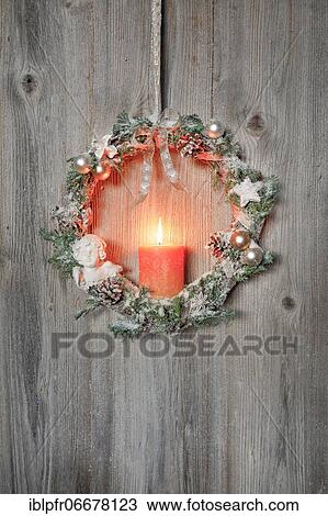 Christmas wreath on wooden wall with candle View Large Photo Image Stock Image - Christmas wreath on wooden wall with candle. Fotosearch