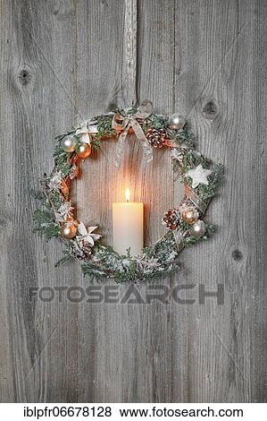 Christmas wreath on wooden wall with candle View Large Photo Image Stock Photo - Christmas wreath on wooden wall with candle. Fotosearch