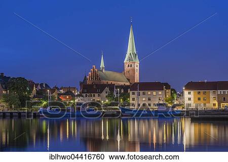 Stock Image - Cityscape at night with St. Olai Church at Öresund in Helsingør, Capital Region of Denmark. Fotosearch
