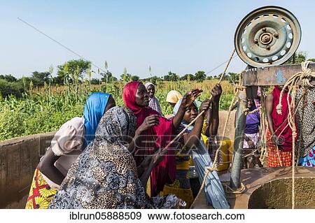 Colourful dressed women fetch water at the well, Dogondoutchi, Niger, Africa View Large Photo Image Stock Photo - Colourful dressed women fetch water at the well, Dogondoutchi, Niger, Africa. Fotosearch
