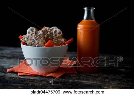 Stock Photo - Cookies with skeleton made of icing in bowl, Halloween. Fotosearch