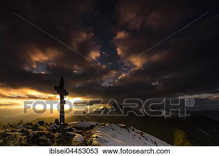 Cross on the summit of Zafernhorn at sunrise with dark clouds, stormy atmosphere, Allgäu Alps, Damüls, Bregenz Forest, Vorarlberg, Austria, Europe View Large Photo Image Stock Image - Cross on the summit of Zafernhorn at sunrise with dark clouds, stormy atmosphere, Allgäu Alps, Damüls, Bregenz Forest, Vorarlberg, Austria, Europe. Fotosearch