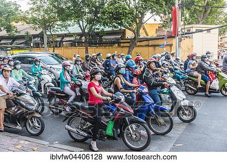 Crowd of scooter riders waiting at traffic light, Ho Chi Minh City, Vietnam, Asia View Large Photo Image Stock Photo - Crowd of scooter riders waiting at traffic light, Ho Chi Minh City, Vietnam, Asia. Fotosearch