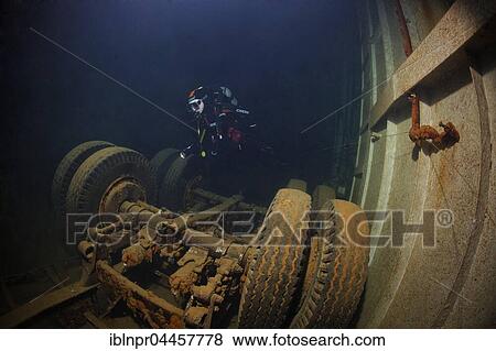 Stock Photo - Diver looking at lorry in hold, El Arish or El Arish El-Tor shipwreck, sunken car ferry, Port Safaga, Red Sea, Egypt, Africa. Fotosearch