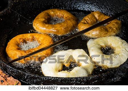 Doughnuts are fried in a pan with hot oil, Bandipur, Tanahun District, Nepal, Asia View Large Photo Image Stock Photo - Doughnuts are fried in a pan with hot oil, Bandipur, Tanahun District, Nepal, Asia. Fotosearch