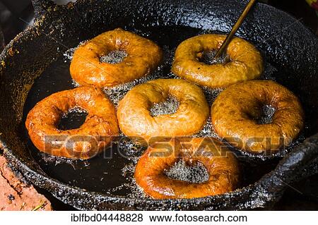 Stock Photo - Doughnuts are fried in a pan with hot oil, Bandipur, Tanahun District, Nepal, Asia. Fotosearch