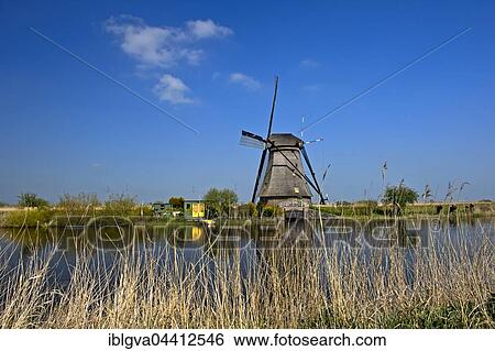 Dutch windmill over a canal, UNESCO World Heritage Site Kinderdijk, Alblasserwaard polder, South Holland, The Netherlands, Europe View Large Photo Image Stock Photograph - Dutch windmill over a canal, UNESCO World Heritage Site Kinderdijk, Alblasserwaard polder, South Holland, The Netherlands, Europe. Fotosearch