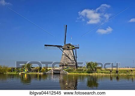 Dutch windmill over a canal, UNESCO World Heritage Site Kinderdijk, Alblasserwaard polder, South Holland, The Netherlands, Europe View Large Photo Image Stock Photography - Dutch windmill over a canal, UNESCO World Heritage Site Kinderdijk, Alblasserwaard polder, South Holland, The Netherlands, Europe. Fotosearch