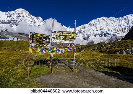 Entrance gate of Annapurna Base Camp, back snow covered Annapurna 1 North Face, right, and the Annapurna South summit, left, Chomrong, Kaski District, Nepal, Asia View Large Photo Image Stock Image - Entrance gate of Annapurna Base Camp, back snow covered Annapurna 1 North Face, right, and the Annapurna South summit, left, Chomrong, Kaski District, Nepal, Asia. Fotosearch
